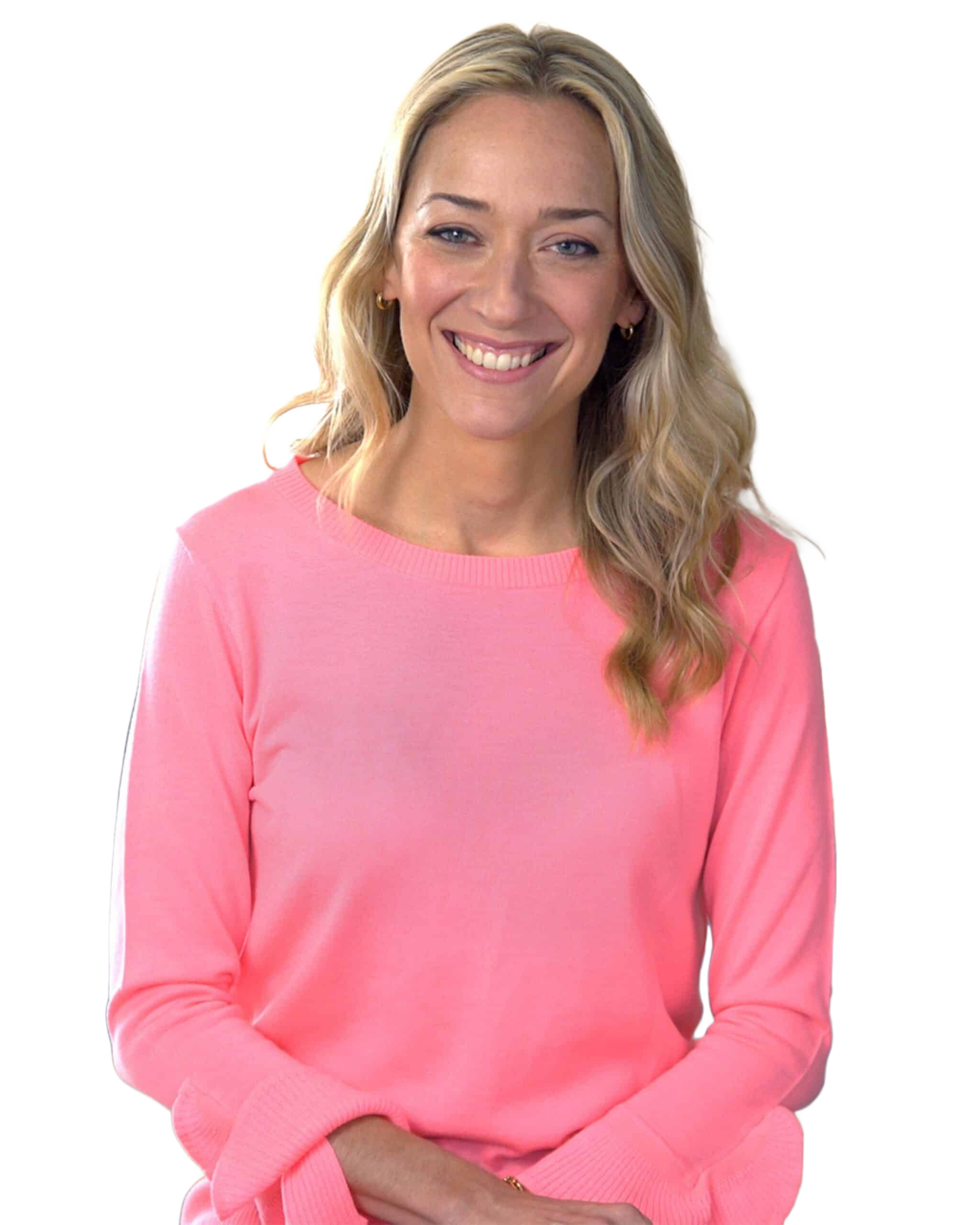 Kris Carr smiling in a pink sweater